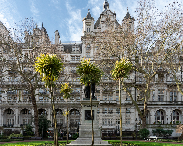 Palm trees hiding Statue of Henry Bartle Frere on embankment, London