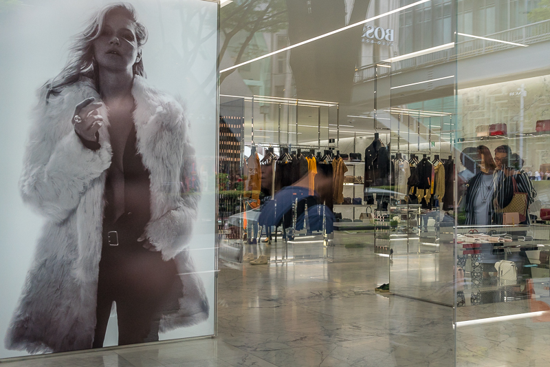 Reflections in YSL shop window with large Kate Moss image inside