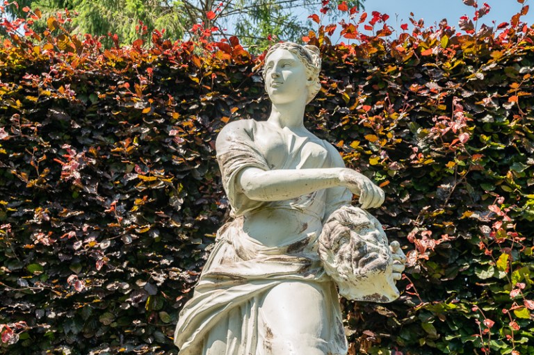 Statue of woman holding severed head of a man