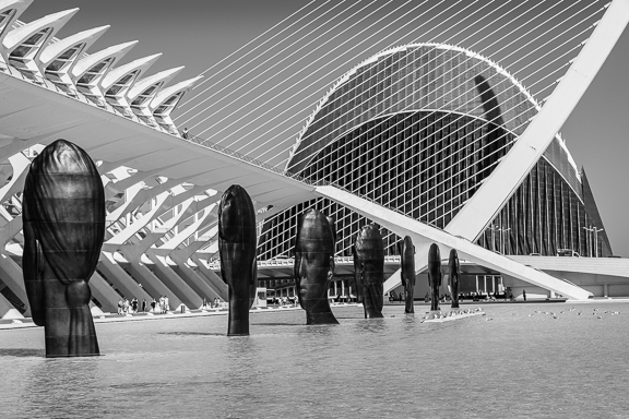 Jaume Plensa head sculptures and Calatrava bridge in the water at the City of Arts and Sciences in Valencia