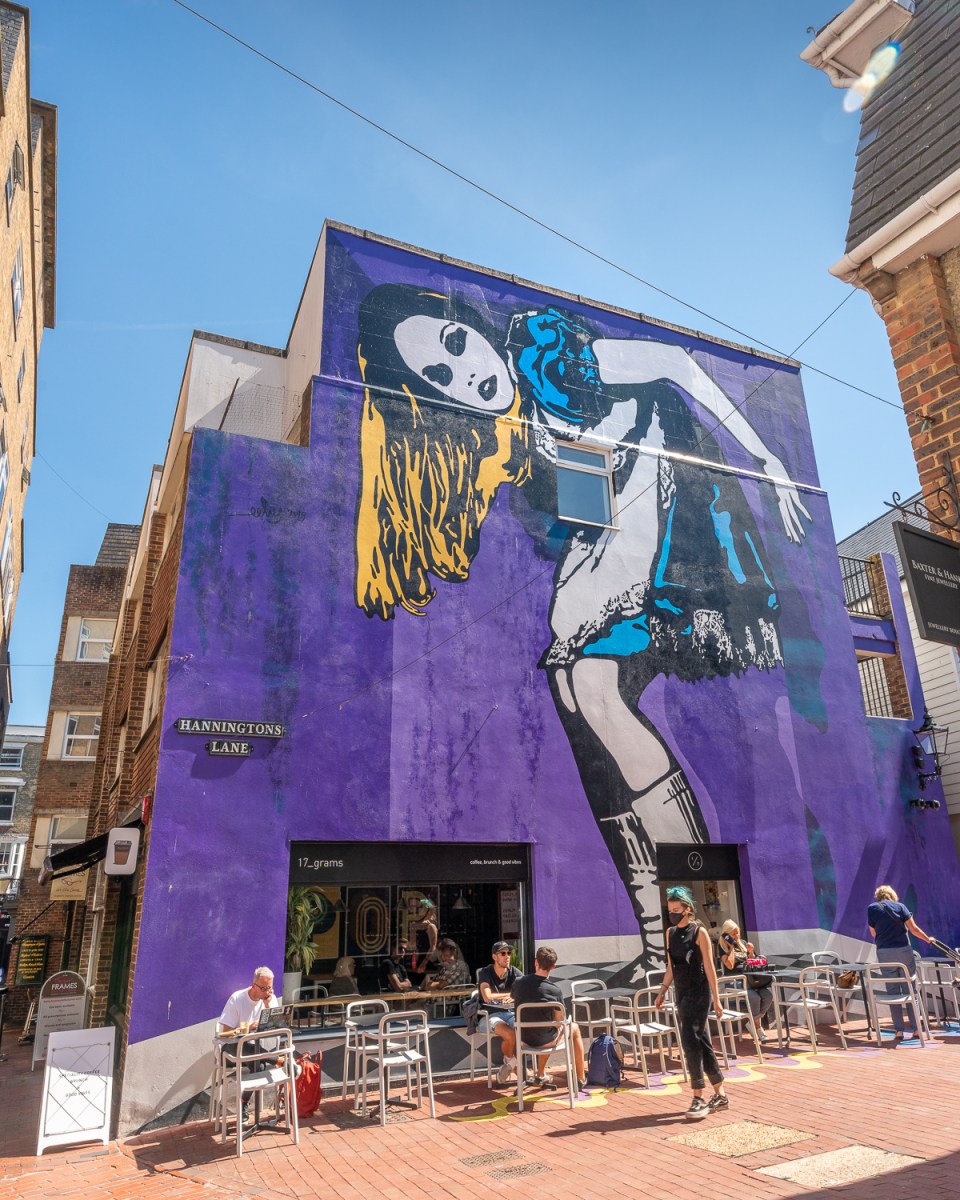 Giant Alice in Wonderland mural on a cafe in Brighton
