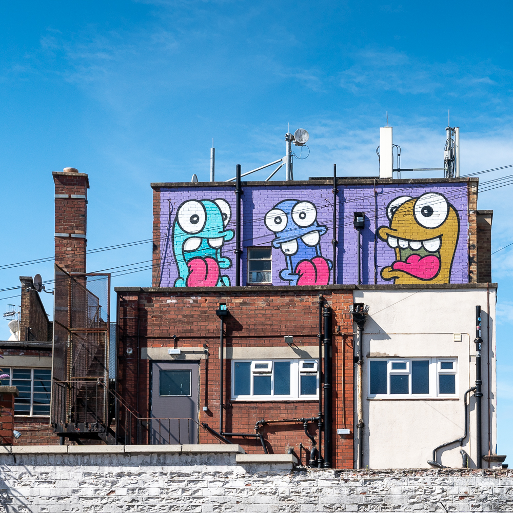street art at the top of a building in Bristol