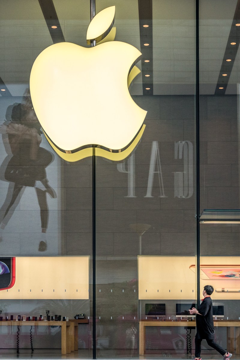 Someone walking past the Apple store in Shanghai