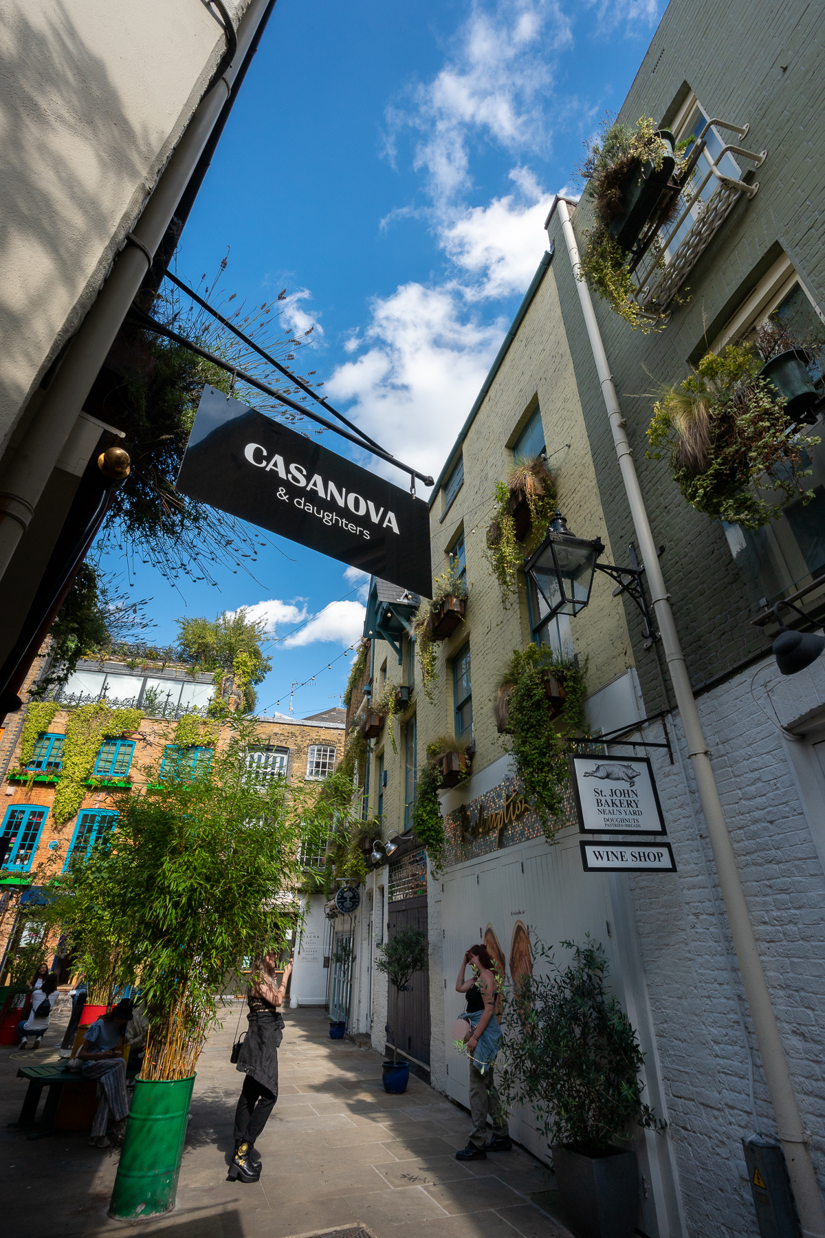 Girl posing in front of angel's wings in Neal's Yard
