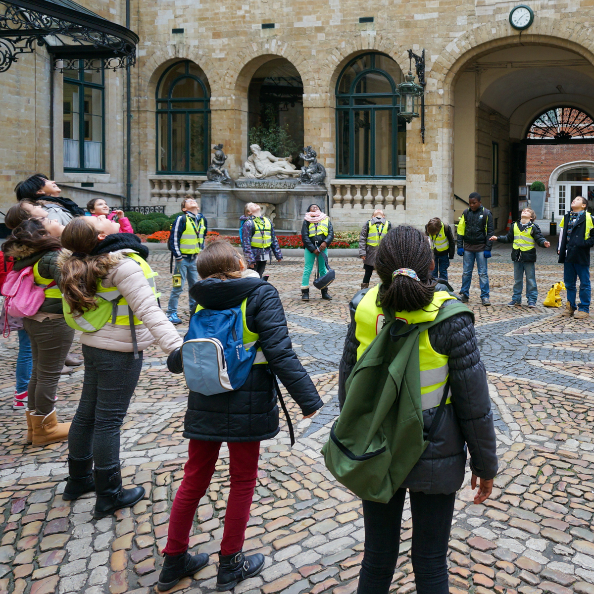 Children in a circle gazing up at sky