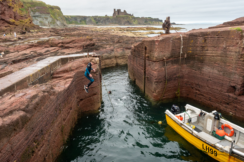 Someone jumping into Seacliff Harbour 