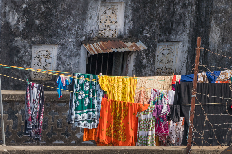 bright clothes on a washing line in front of an old wall in Stone Town