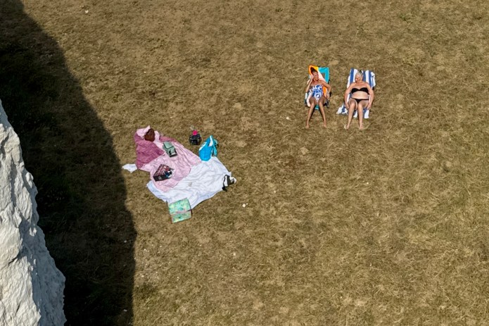 Two friends relaxing beside the&nbsp;seaside